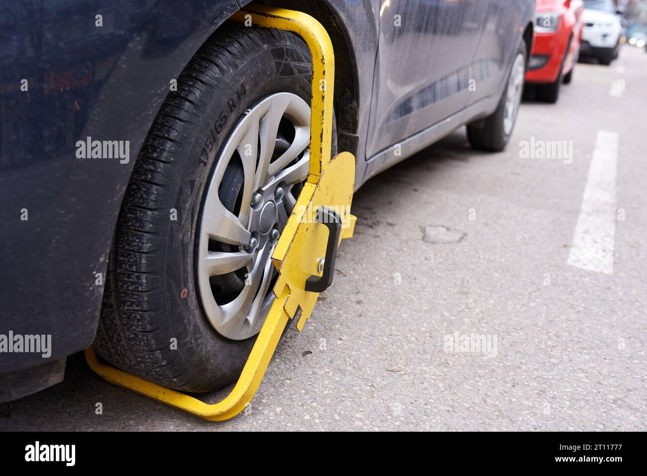 Tire lock on a car for illegal parking violation. blocked wheell Stock
