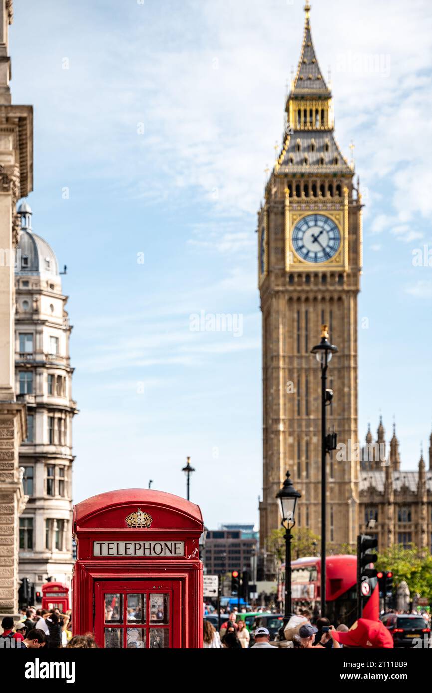 London, UK, 07th Oct. 2023: People queue up in front of a red telephone box at Great George Street for taking pictures, Big Ben in the background. Stock Photo