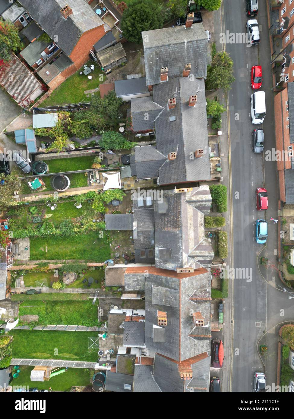 Aerial view of semi detached housing with gardens and on street car