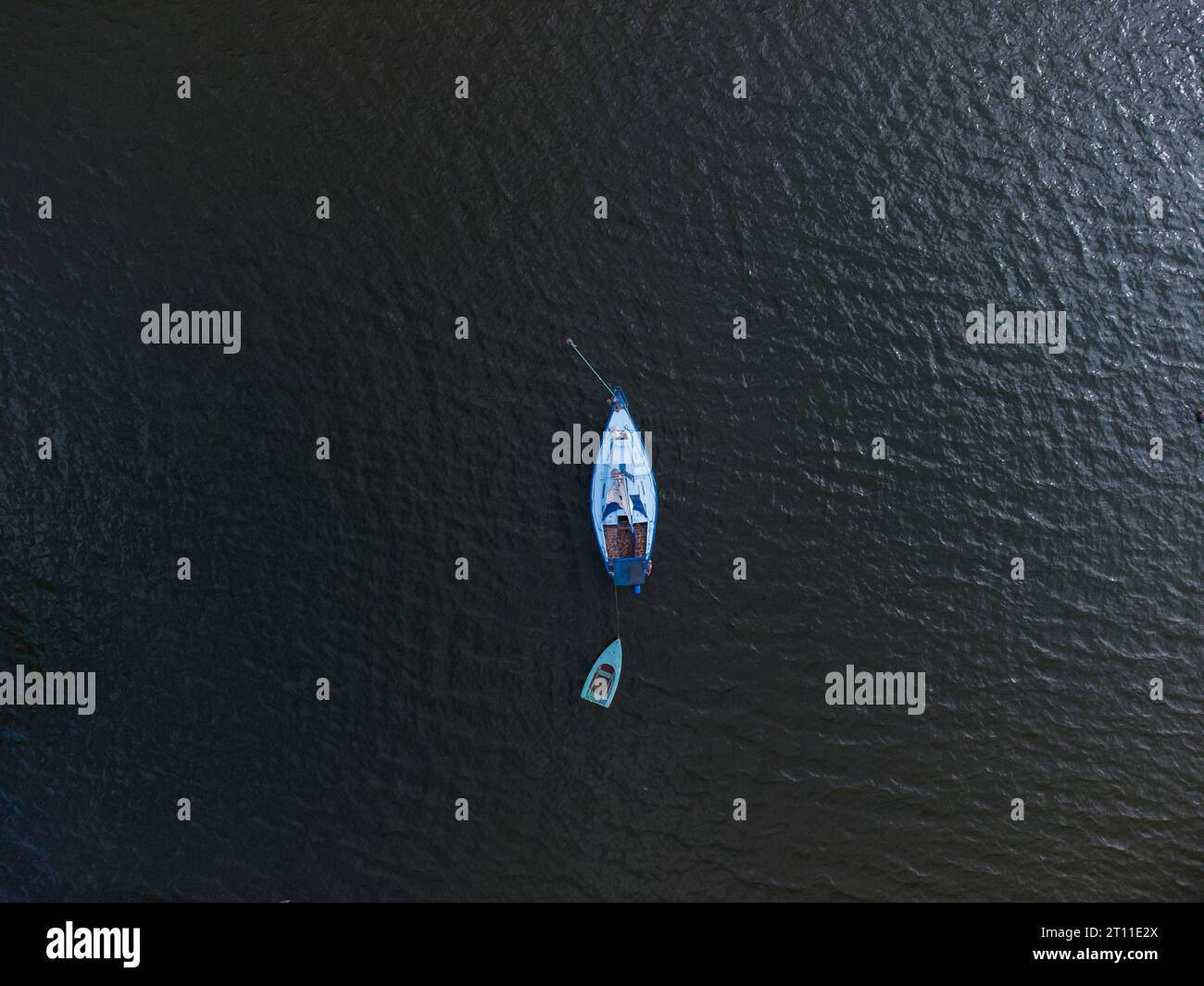 Aerial top view of a boat sailing in the lake Stock Photo - Alamy