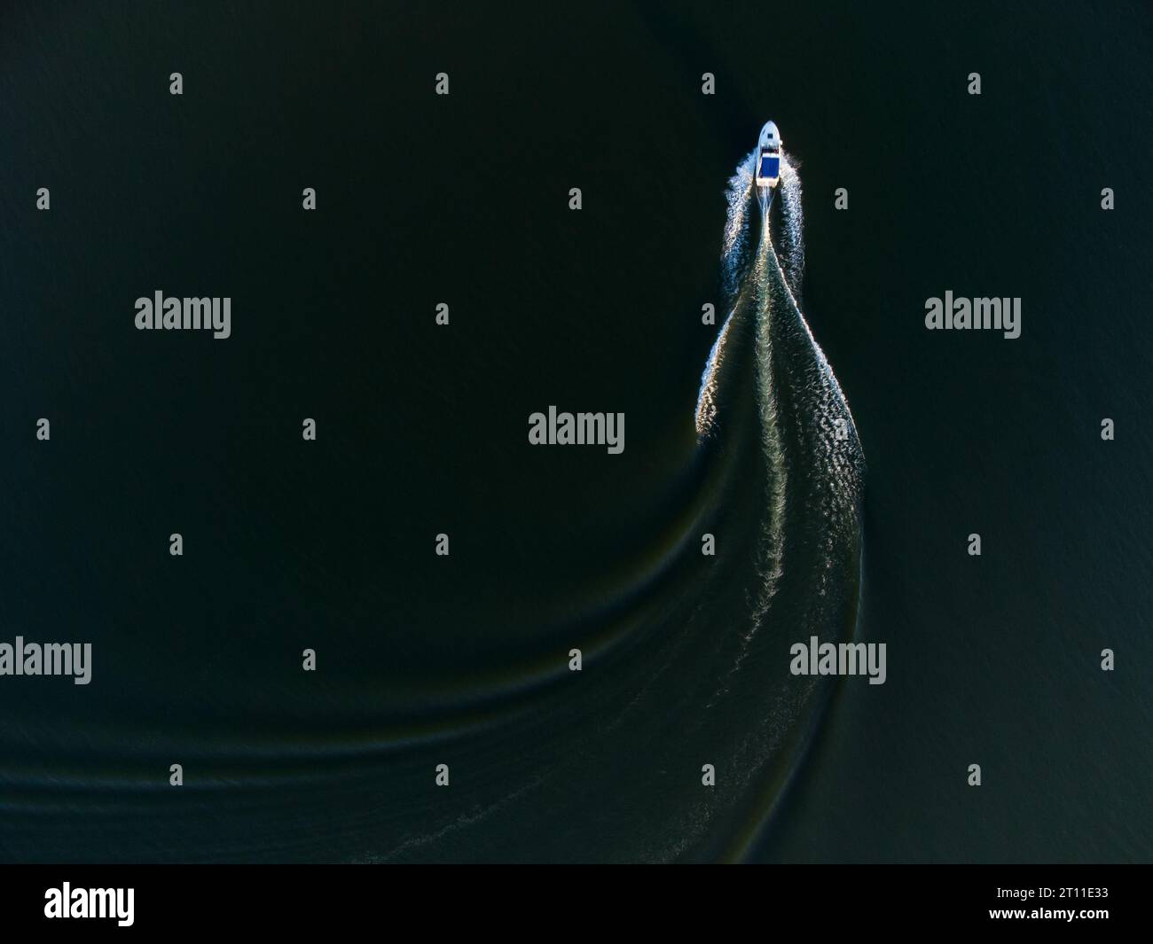 Aerial top view of a boat sailing in the lake Stock Photo - Alamy