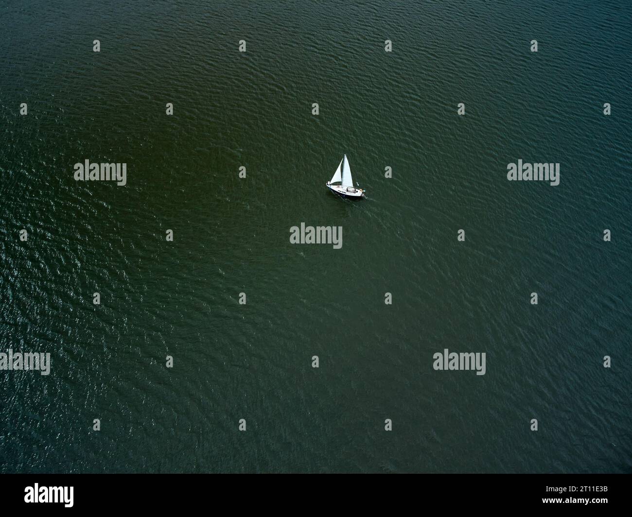 Aerial top view of a boat sailing in the lake Stock Photo - Alamy