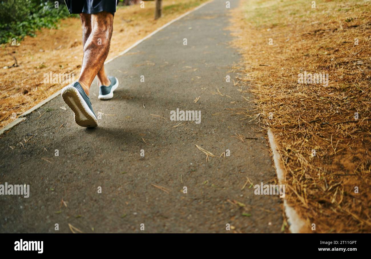male runner in compression calf sleeve run over rocks Stock Photo