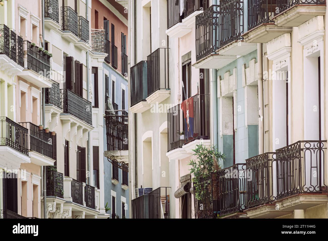 Stunning row of balconies on street buildings in Pamplona! The intricate facades and vibrant colors add a charming touch to the neighborhood Stock Photo