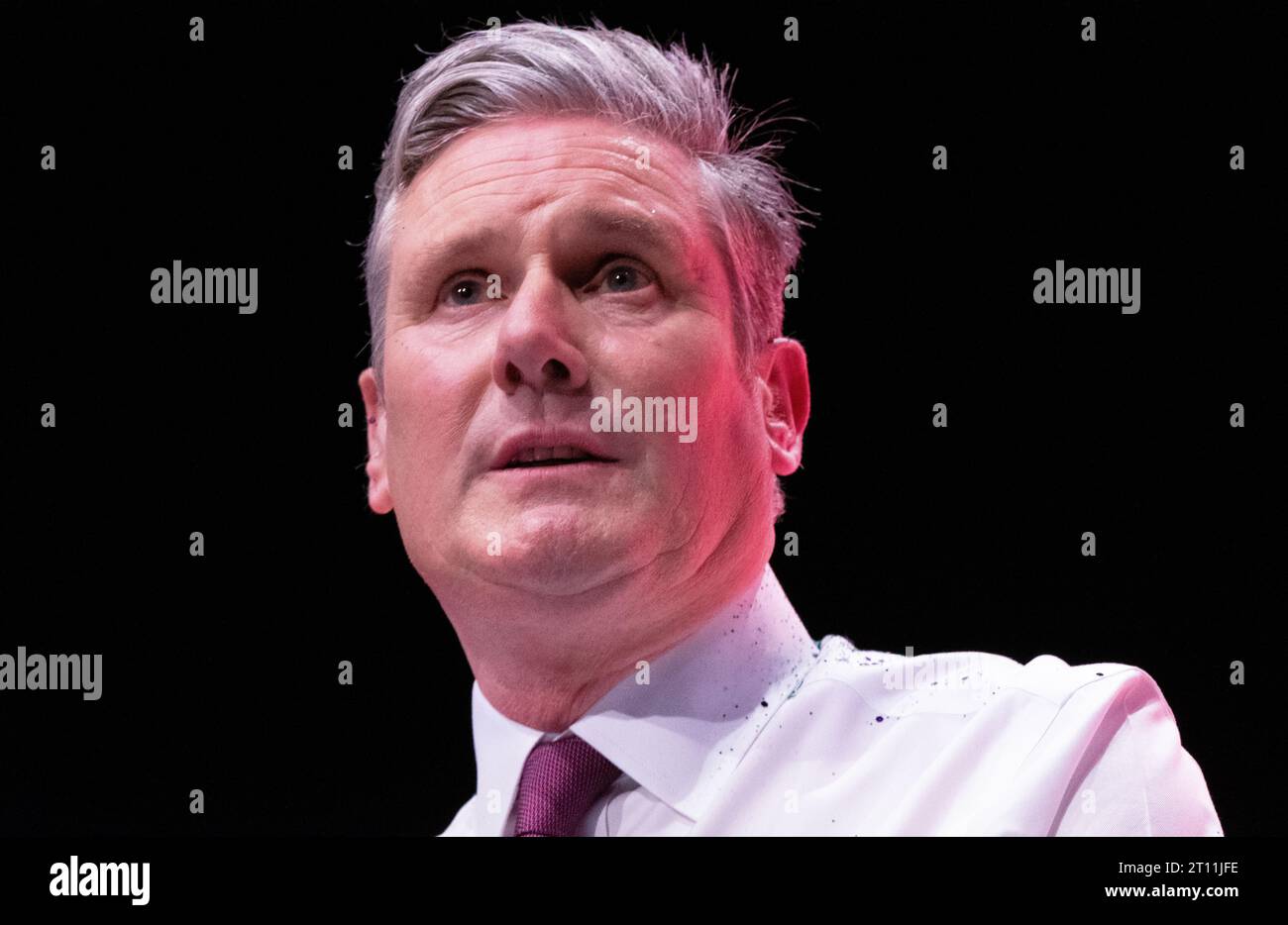 Keir Starmer with glitter during the start of the leaders speech.The protester was wrestled to ground and removed by security. Sir Keir Brushed his hair removed his jacket and carried on with speech. His shirt, hands and the floor around him was covered in glitter and remained so throughout the speech. Labour Conference 2023. Credit: GaryRobertsphotography/Alamy Live News Credit: GaryRobertsphotography/Alamy Live News Stock Photo