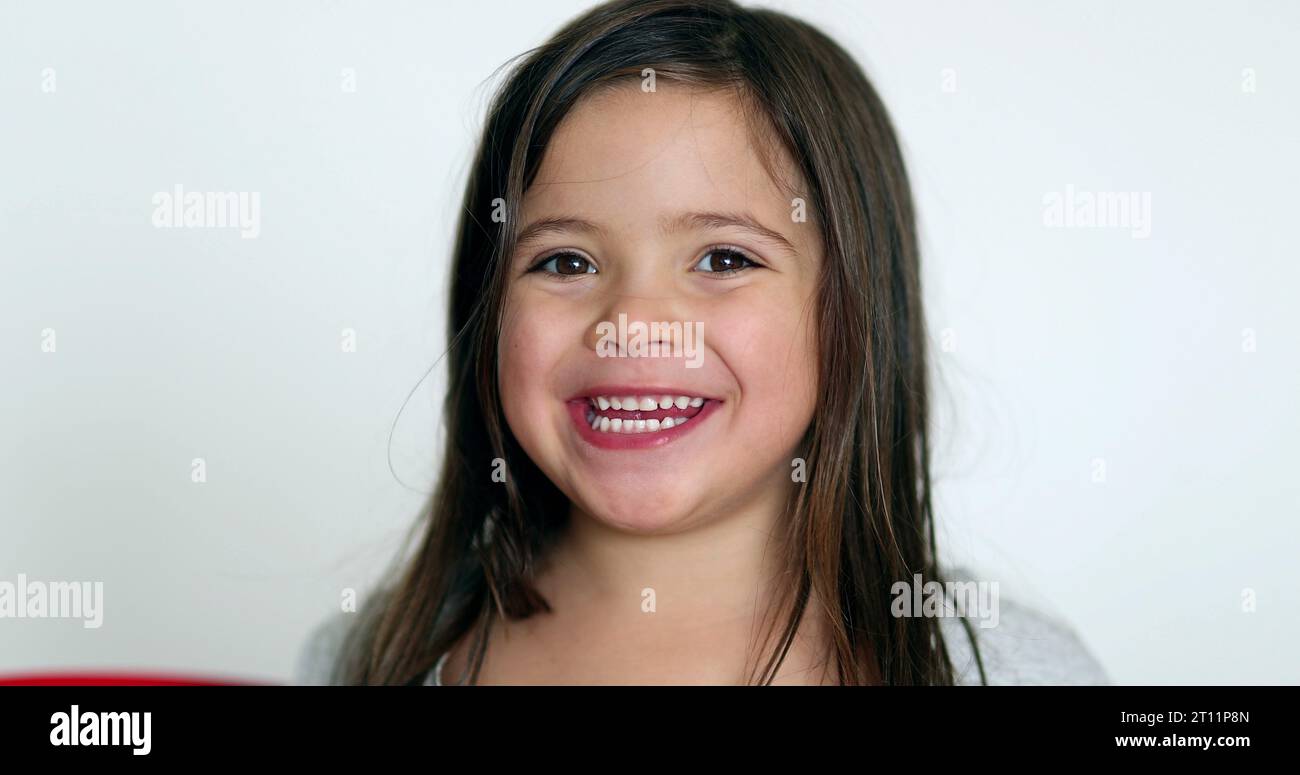 Happy little girl smiling at camera. Cute adorable child portrait face ...