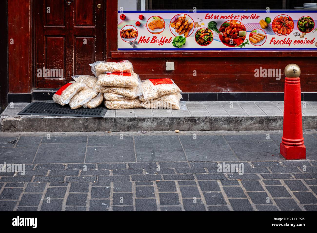 Packages of Noodles, just delivered, lying in front of a restaurant in Chinatown, London, UK. Stock Photo