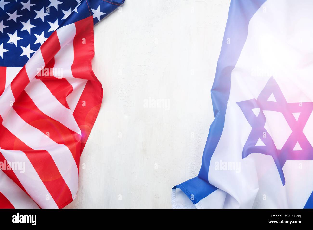 Israel USA flags. Two American and Israeli flags lie on white old concrete wall texture background opposite each other conveys partnership between two Stock Photo