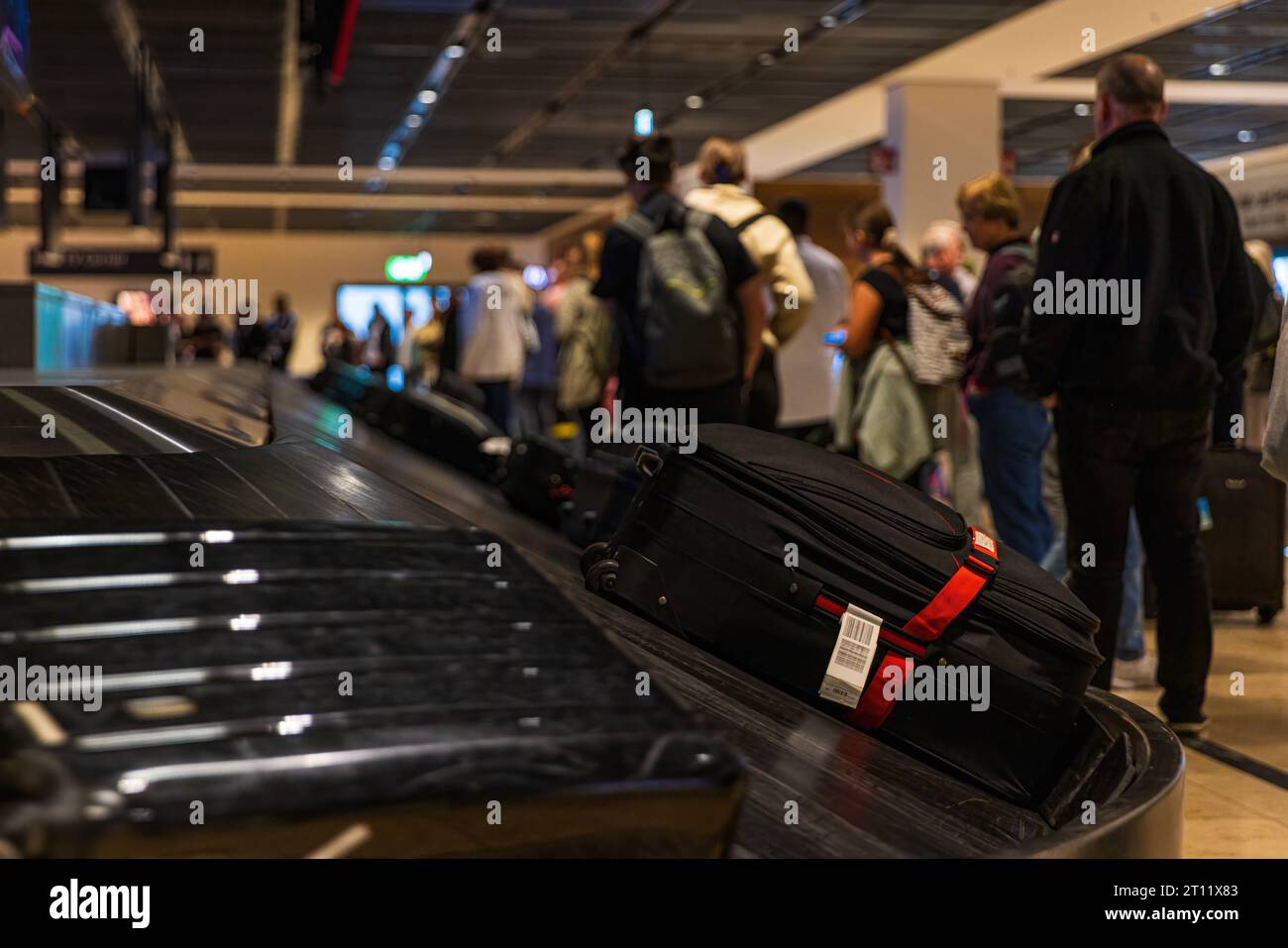 BERLIN, GERMANY OCTOBER 9, 2023 Suitcase on luggage conveyor belt in