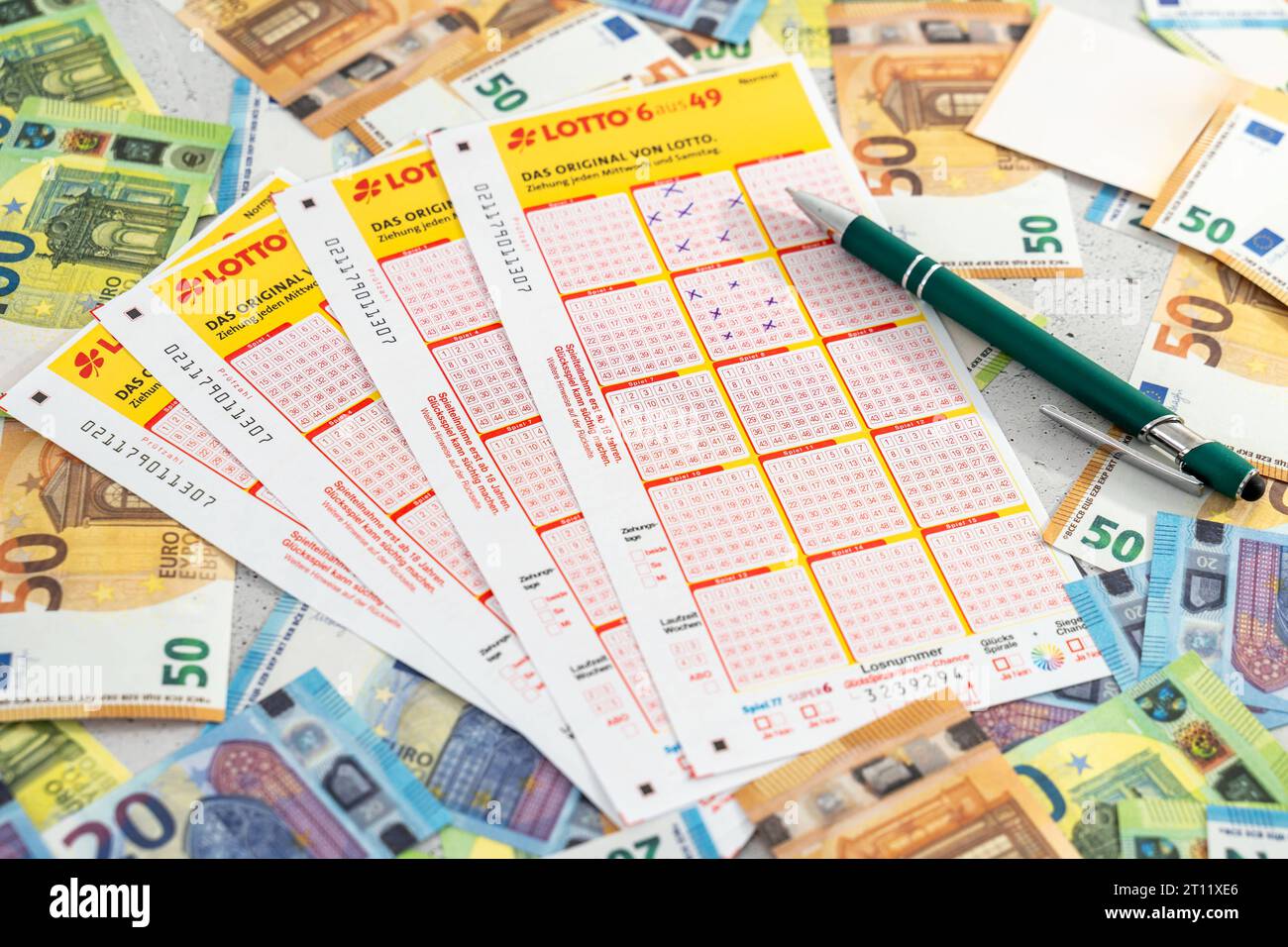 Augsburg, Bavaria, Germany. 10th Oct, 2023. Lotto 6 out of 49 tickets on Euro cash bills. Gambling Lottery *** Lotto 6 aus 49 Spielscheine auf Euro Bargeld Scheinen. Glücksspiel Lotterie Credit: Imago/Alamy Live News Stock Photo