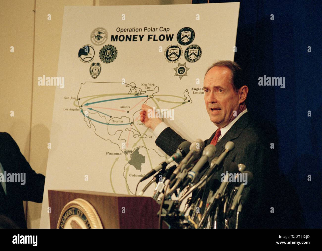 Attorney General Dick Thornburgh points to a map during a news