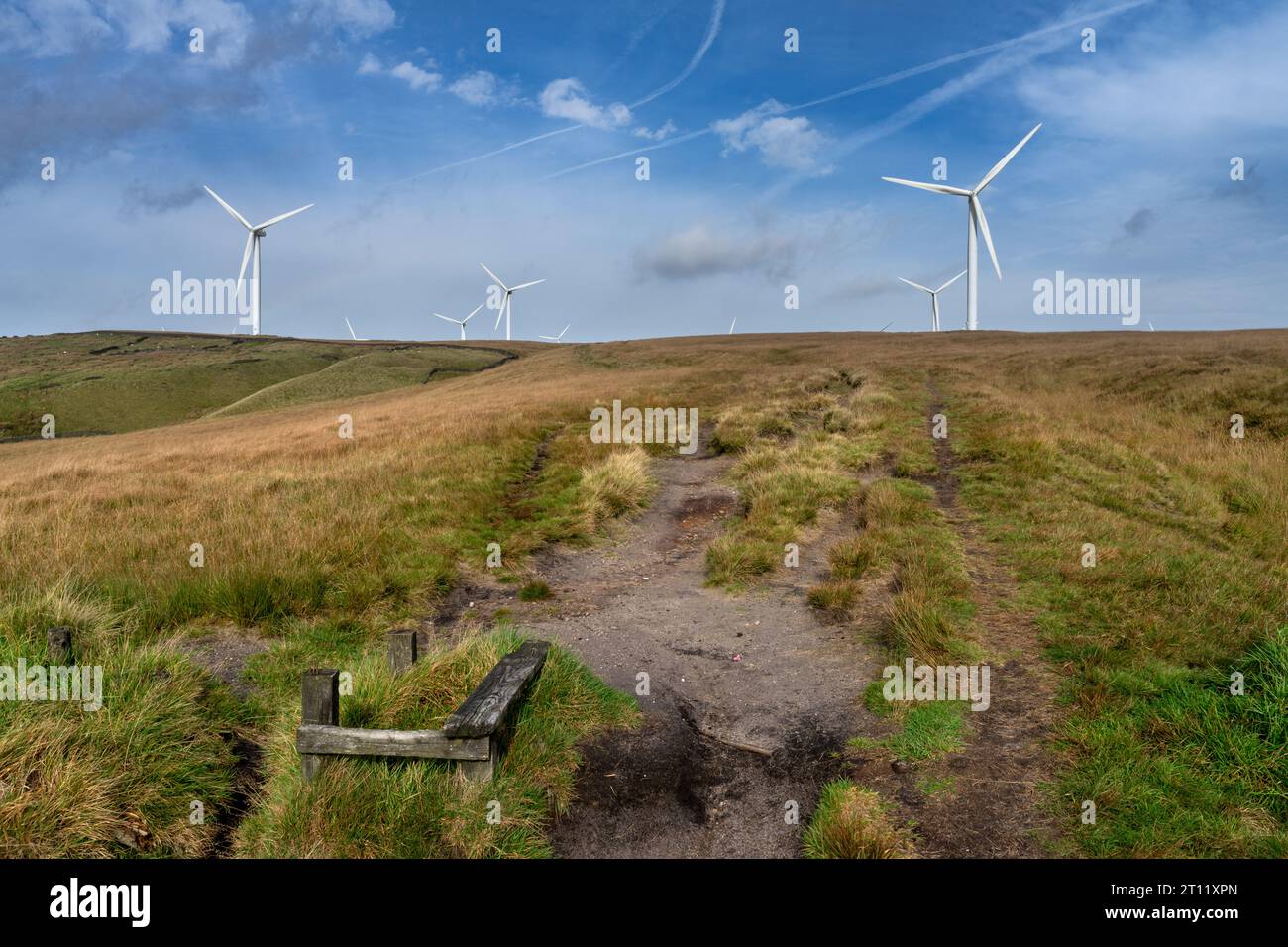 Scout Moor wind farm energy producing turbines with footpath leading