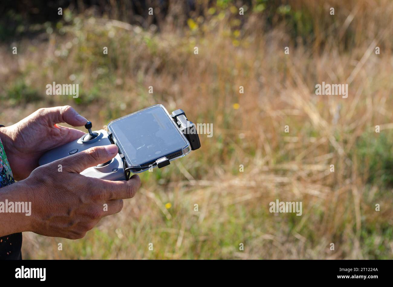 Hands of a man operating a drone Stock Photo