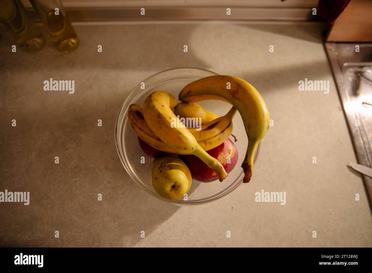 Organic bananas on red background top view. Bunch of bananas is lying on  orange background with dark spots marking ripening process Stock Photo -  Alamy