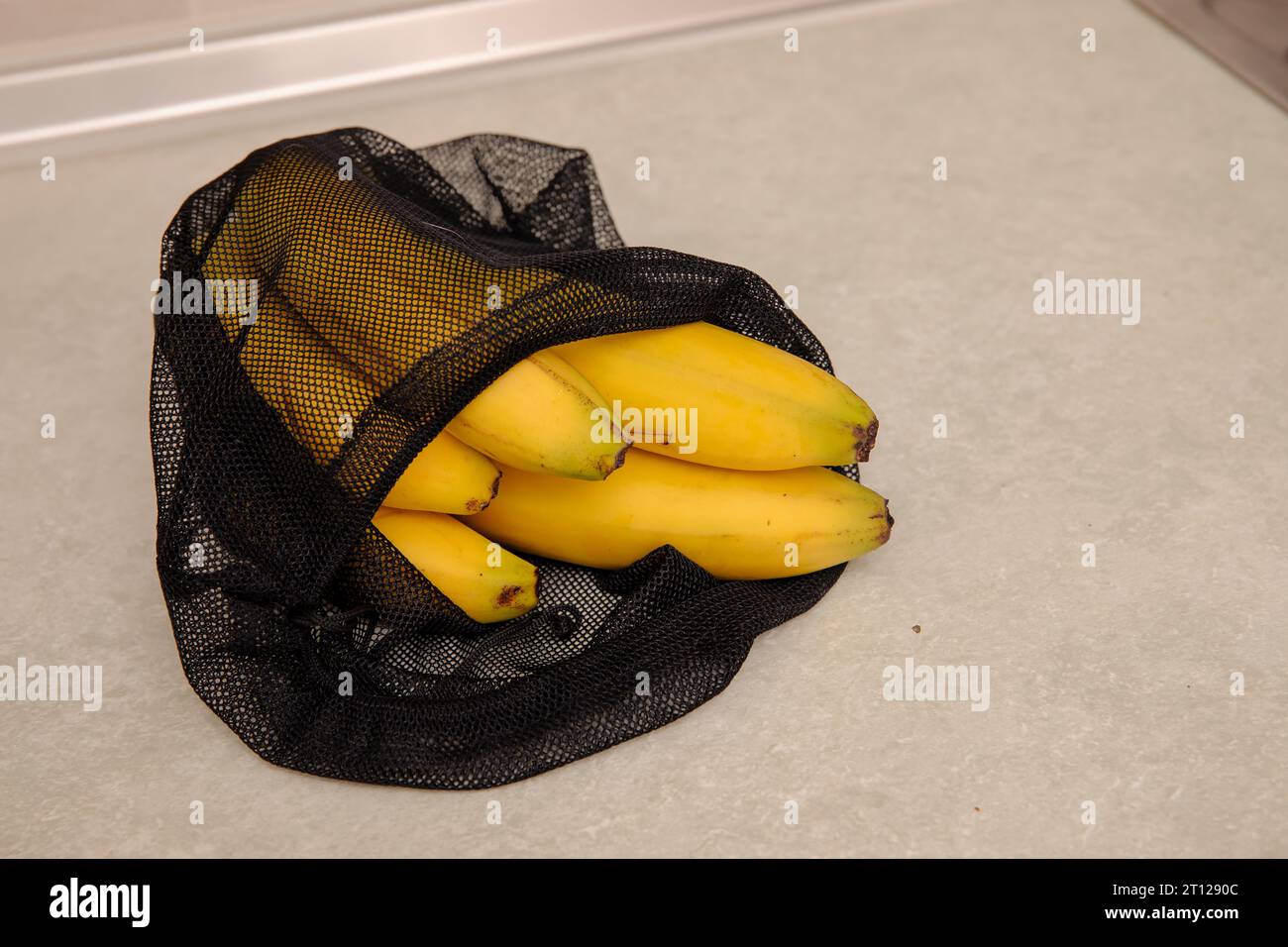 Bananas in eco friendly net bag Stock Photo Alamy