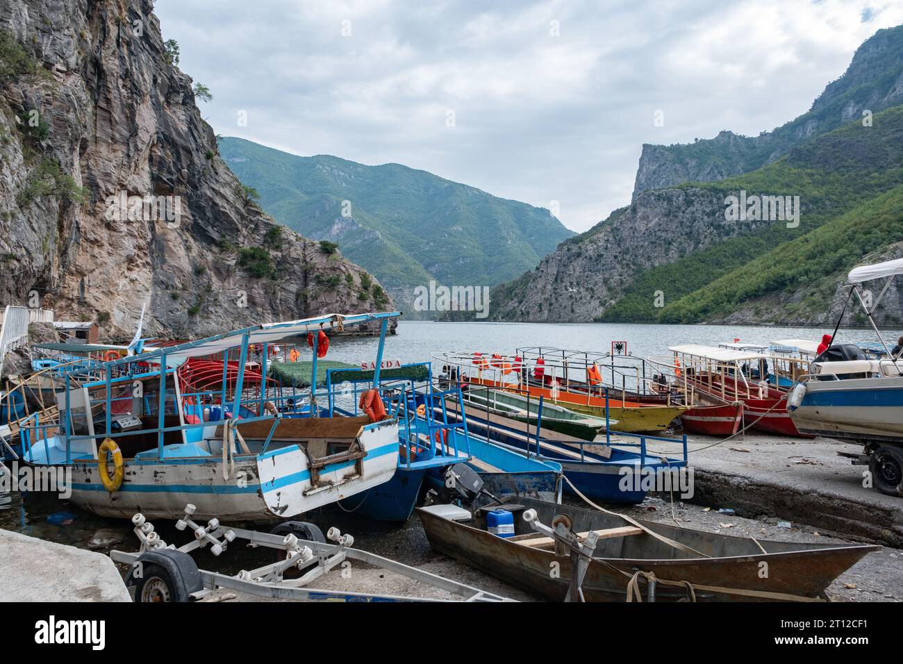 The port and day tripper boats at Lake Komani, Albania Stock Photo