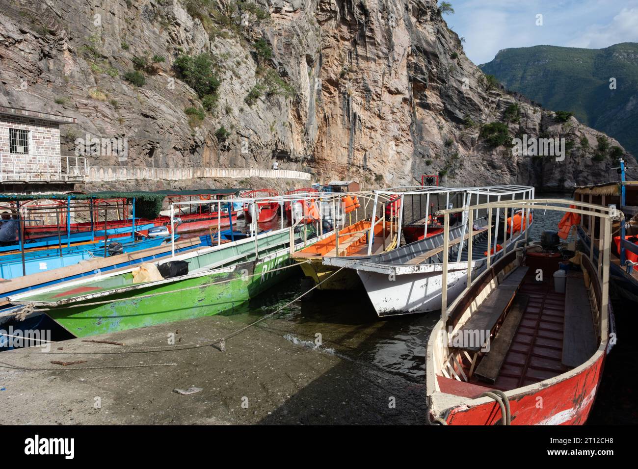 The port and day tripper boats at Lake Komani, Albania Stock Photo