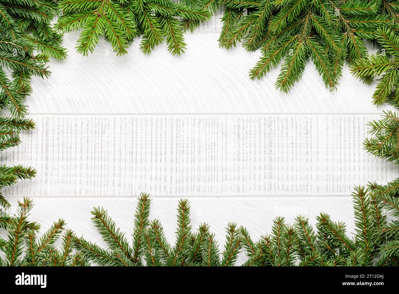 Christmas fir tree branch frame over white wood with space for ...
