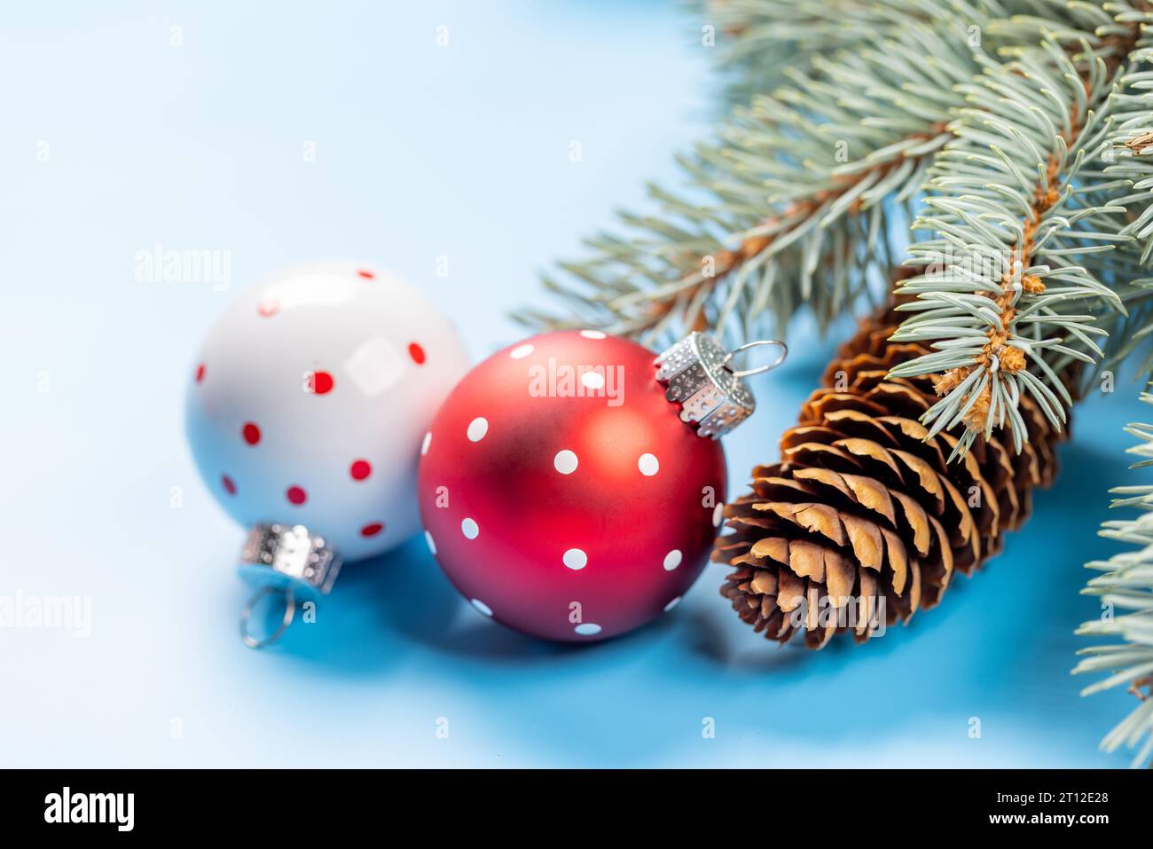 Christmas fir tree branch and bauble decor over blue background with ...