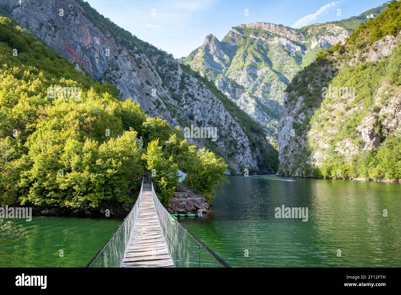 A wooden rope bridge over the water at Lake Komani, Albania Stock Photo