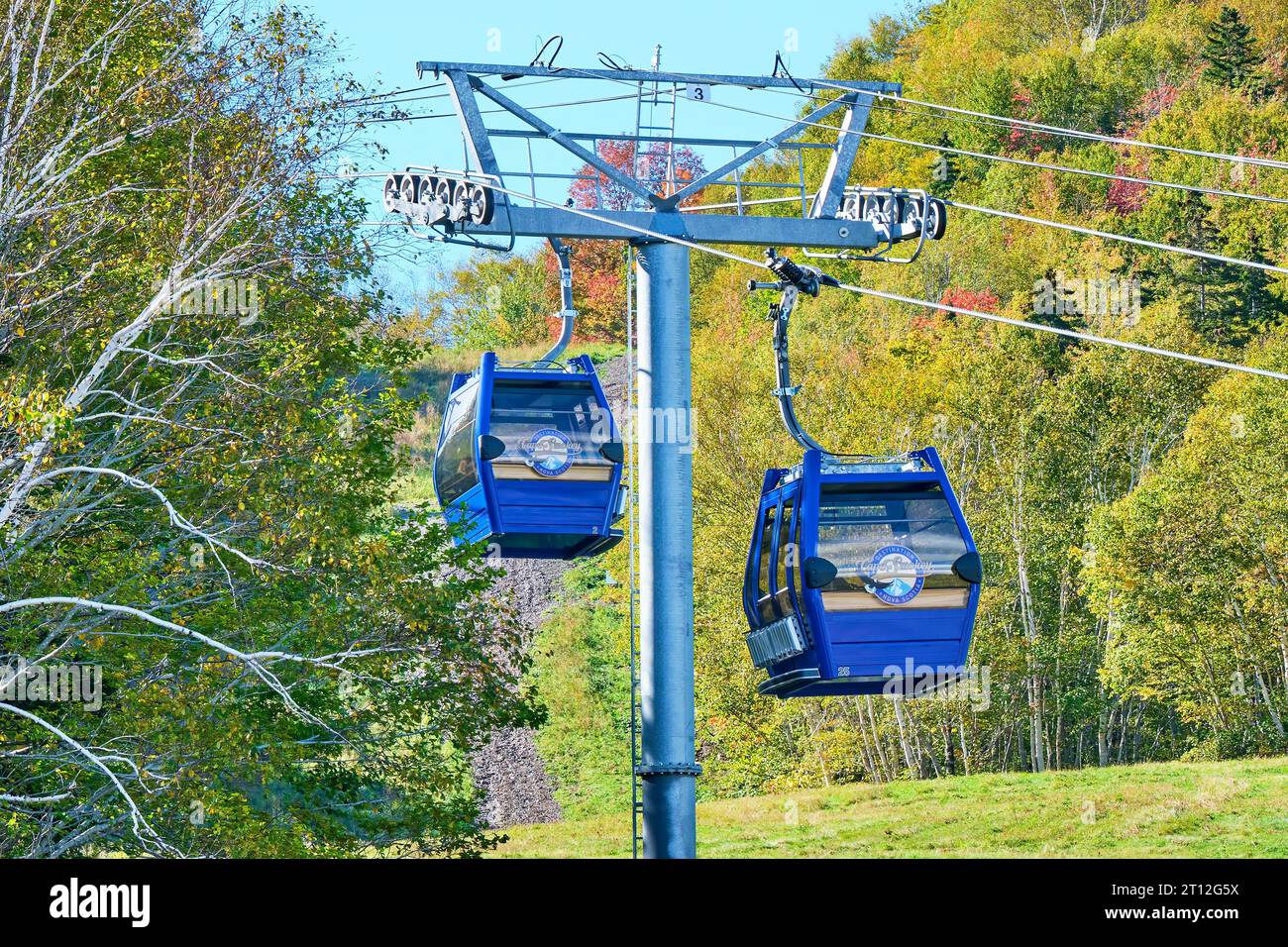 Cablecars take visitors to the top of the Cape Breton Highlands where they can enjoys beautiful views of the Atlantic Ocean and Cape Smokey. Stock Photo
