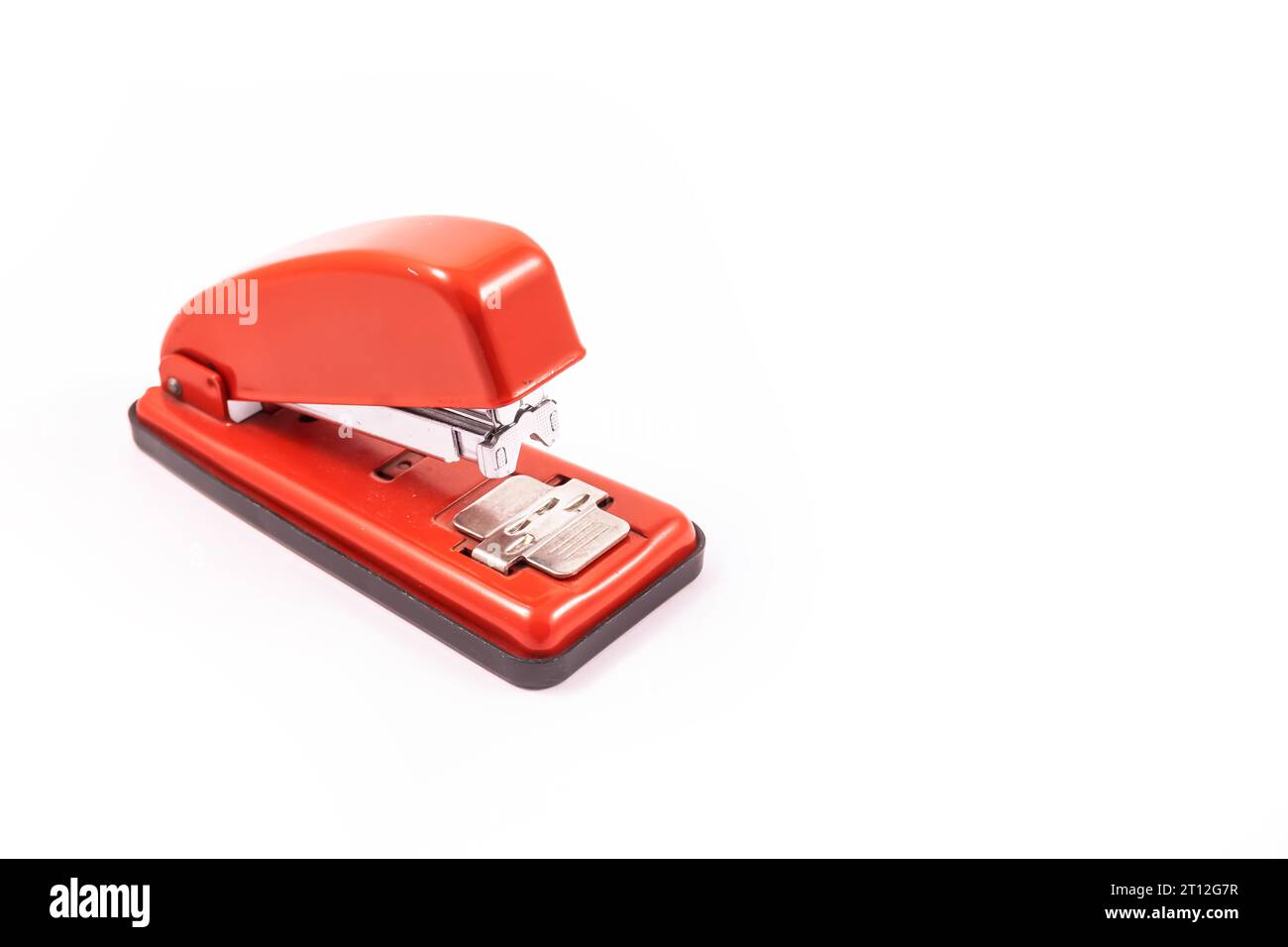 Detail of a red handheld stapler on a white background copy and paste