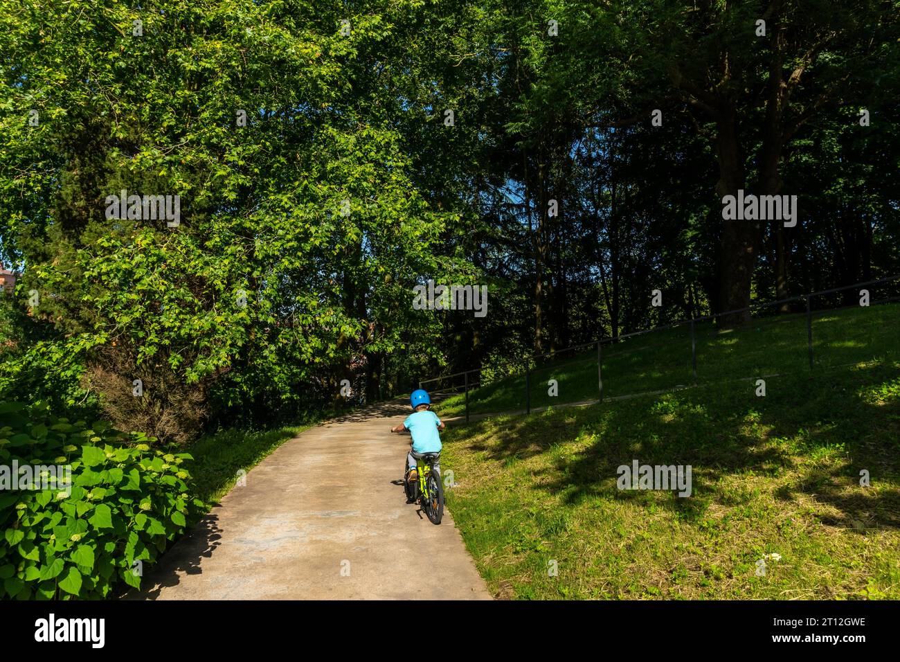 Children on bikes in a park in the municipality of Lezo, a small coastal town in the province of Gipuzkoa, Basque Country. Spain Stock Photo