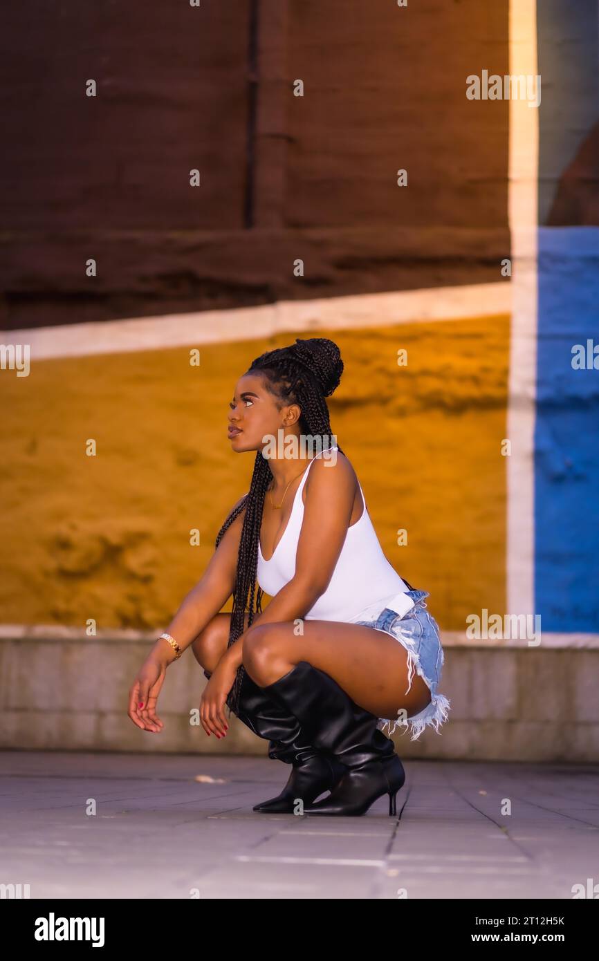 Fashionable urban style with an African girl with braids on a street in ...