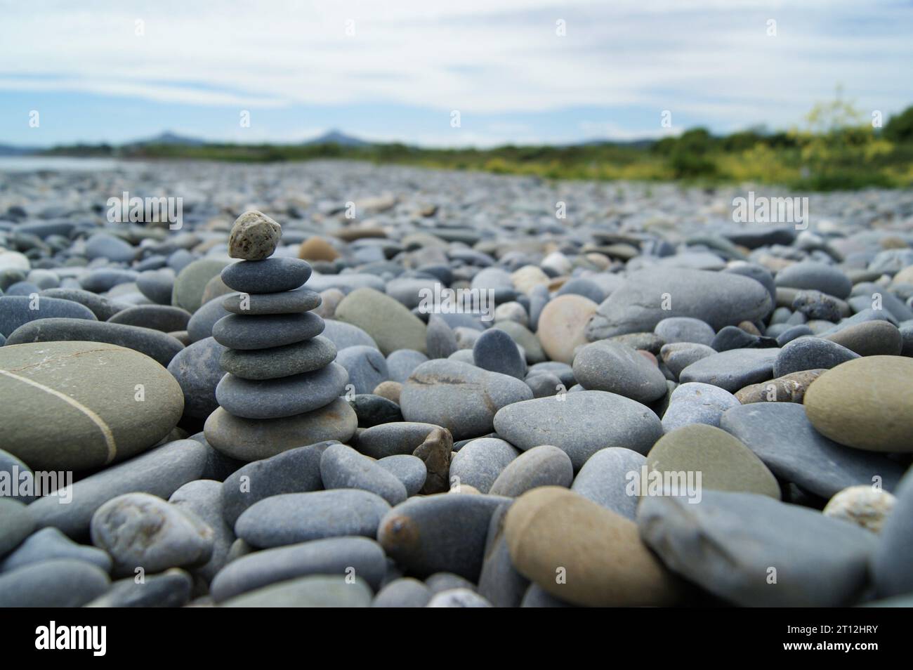 Zen tower on a rocky beach. Various pebbles on the beach. Stock Photo