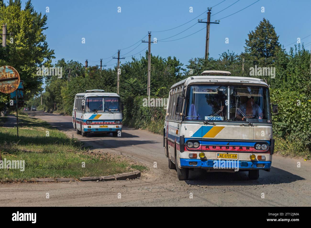 21.08.2019. Ukraine, Pokrov, road from bus depot. Two Autosan H9 have left garage to pick up miners after their work. Stock Photo