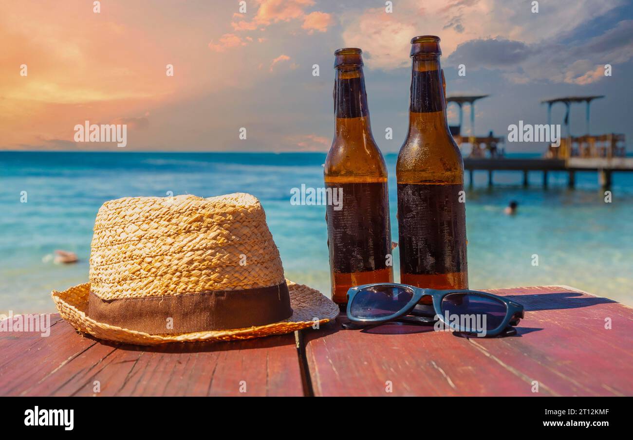 Two beers, sunglasses and a hat on West End beach on Roatan Island ...