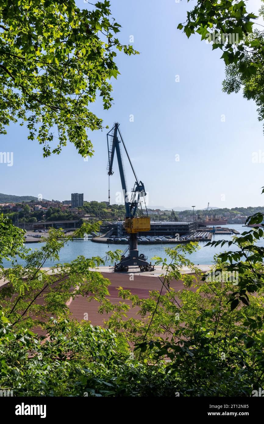 Crane of the port of Pasajes in the municipality of Lezo, the small coastal town in the province of Gipuzkoa, Basque Country. Spain Stock Photo