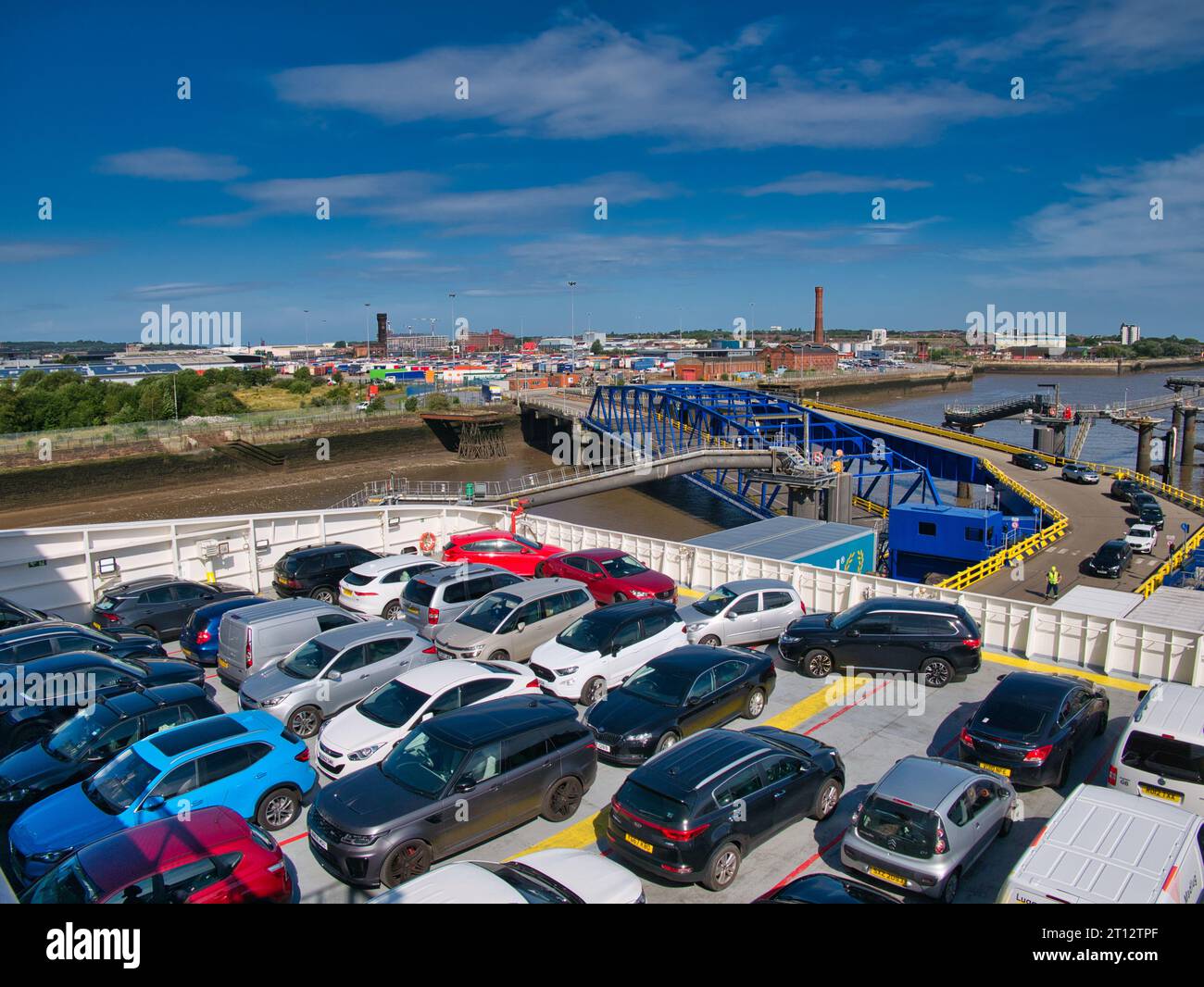 Cars on the upper vehicle deck of the Stena Line ferry leaving Birkenhead on the River Mersey for Belfast in Northern Ireland. The linkspan is in the Stock Photo