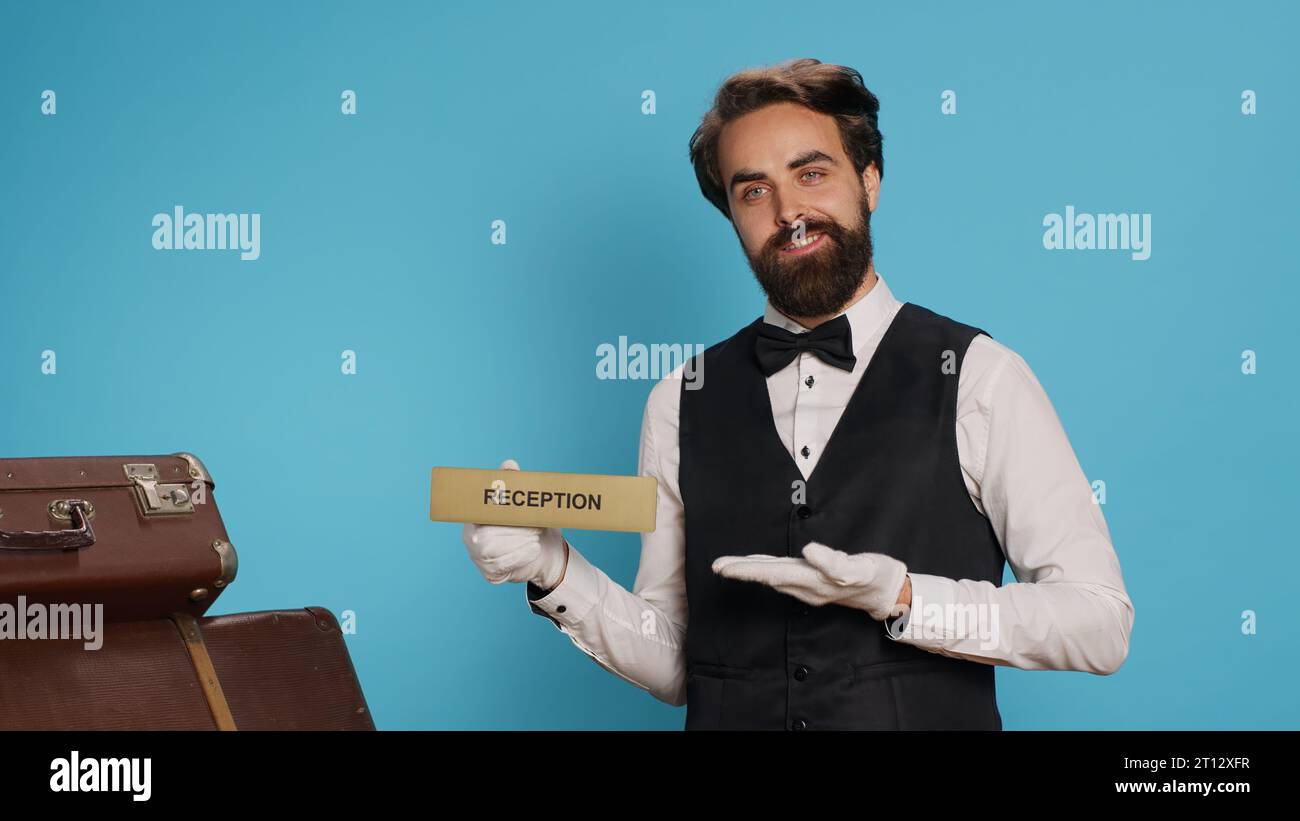 Hotel staff uses reception indicator on camera, guiding people in the ...