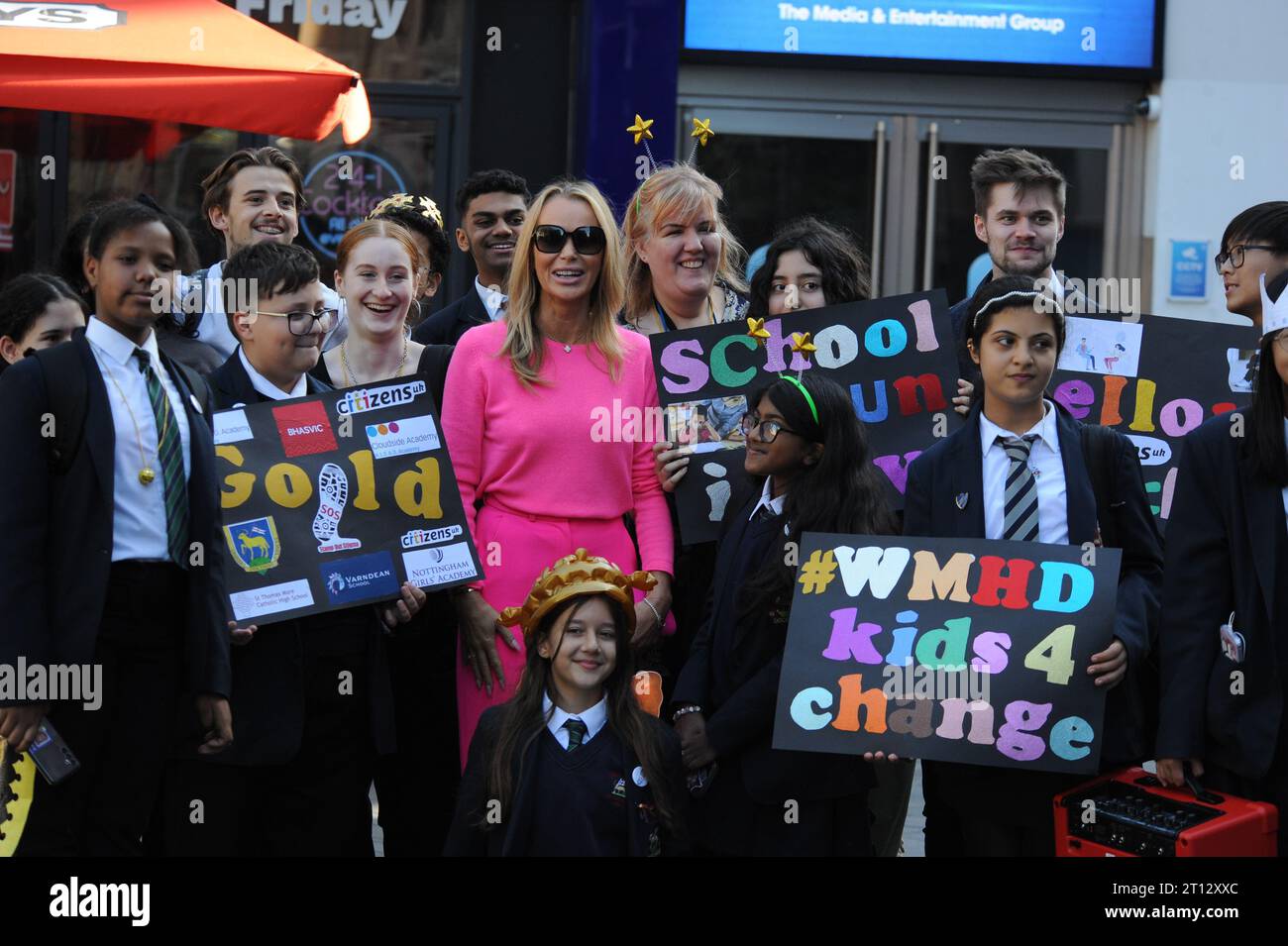 Leicester Square, London, UK. Amanda Holden joins up with pupils from