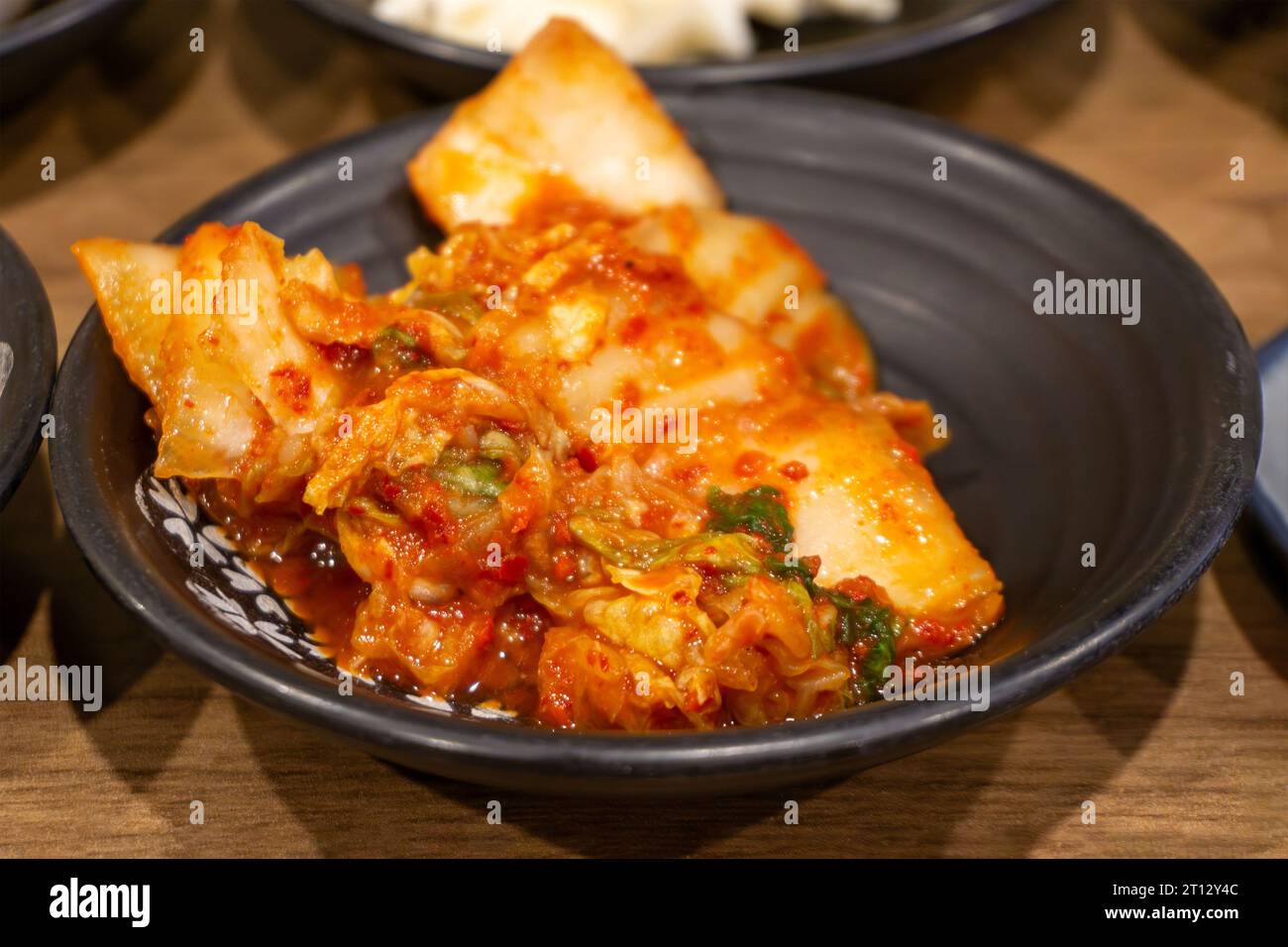 Spicy Korean fermented or aged cabbage known as Kimchi which is a traditional mainstay in Korean cuisine. Stock Photo