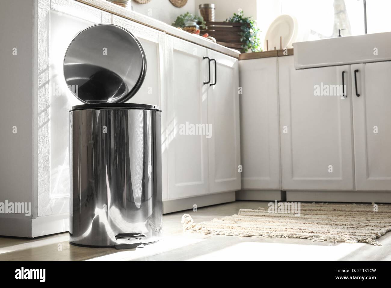 Opened metallic trash bin on floor in modern kitchen Stock Photo - Alamy