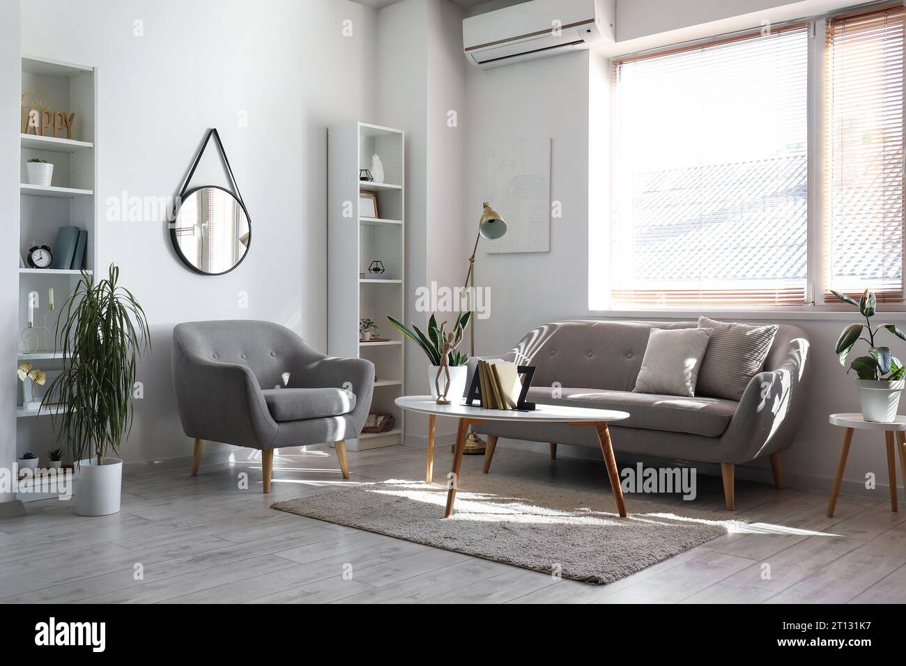 Interior of light living room with sofa, armchair and table Stock Photo ...
