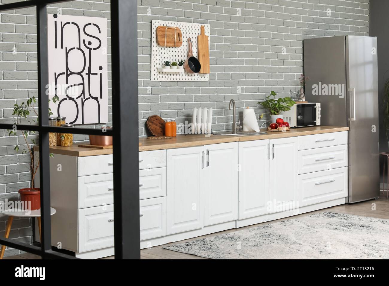 Interior of modern kitchen with white counters and fridge Stock Photo ...