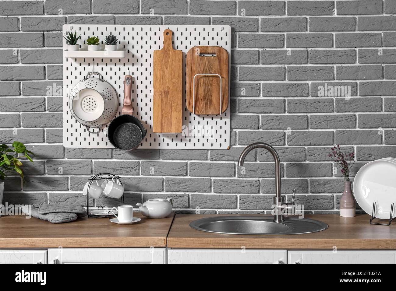 Modern kitchen with pegboard, sink and utensils Stock Photo Alamy