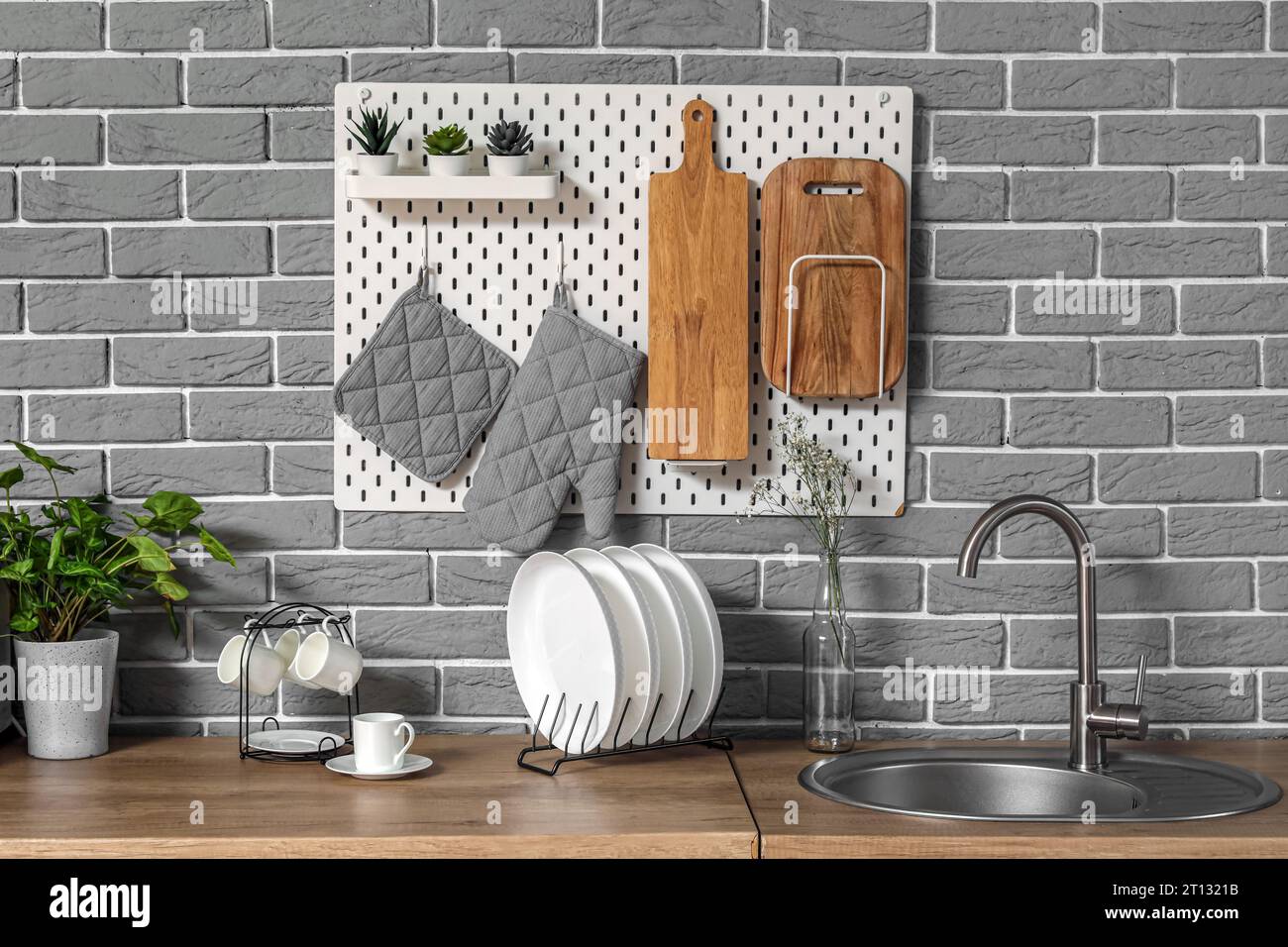 Modern kitchen with pegboard, sink and utensils Stock Photo Alamy