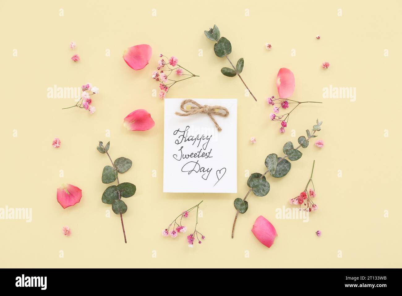 Greeting card with text HAPPY SWEETEST DAY and rose flowers on yellow