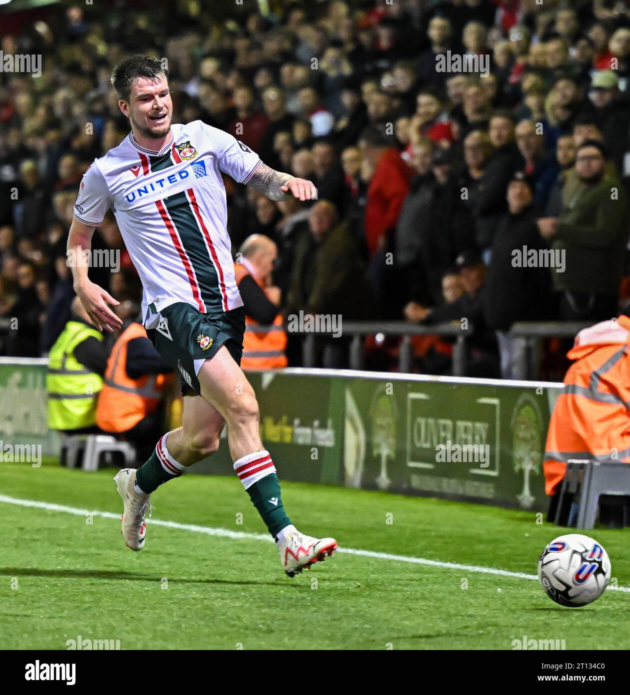 Liam McAlinden 11 of Wrexham Association Football Club chases down the