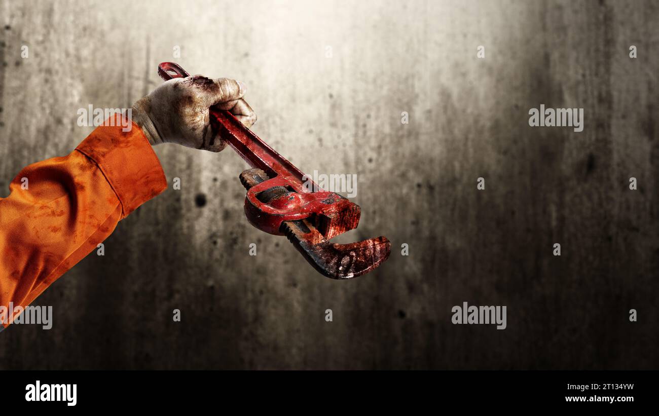 The hand of a scary construction worker zombie with blood and wounds
