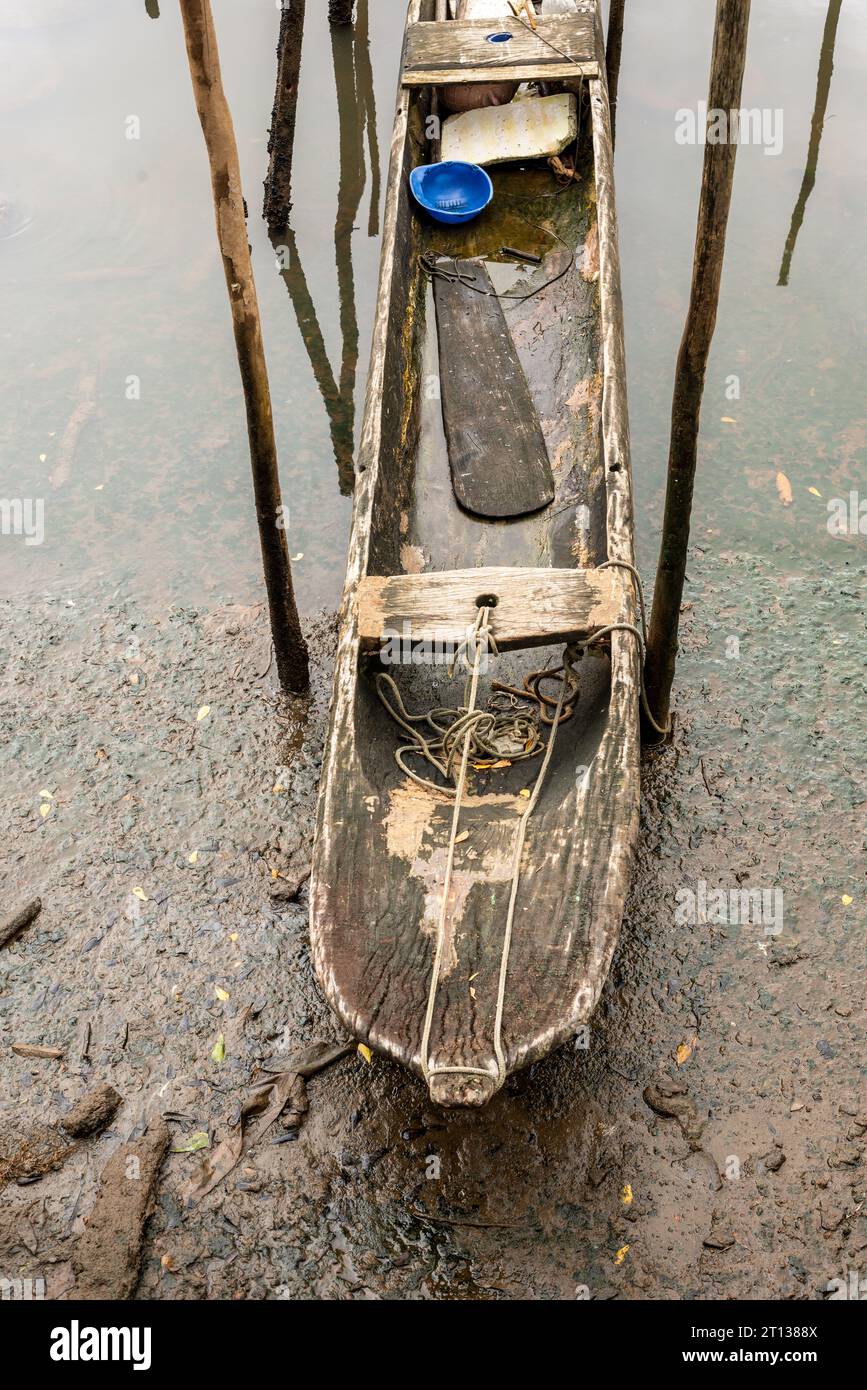 A fishing and transport canoe stops on the riverbank. Family support