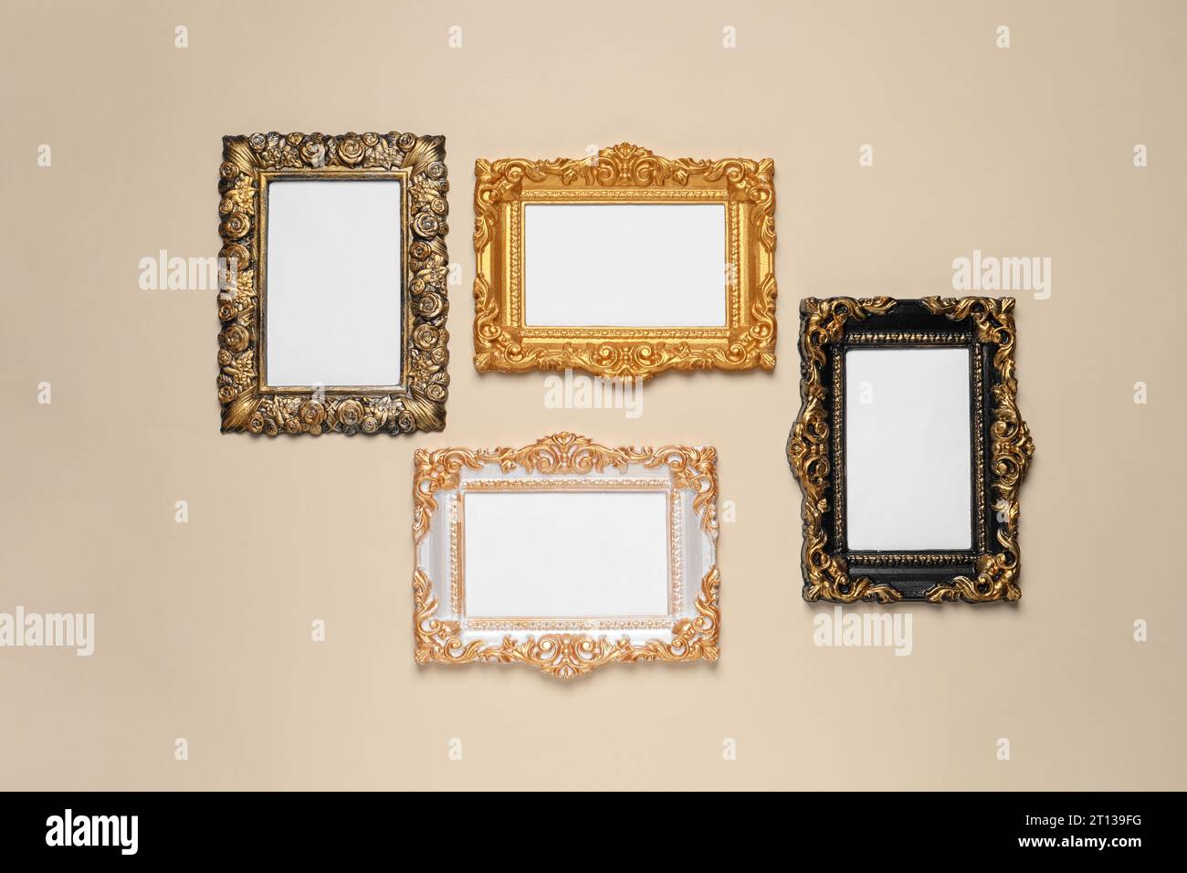 Empty vintage frames hanging on beige wall Stock Photo - Alamy