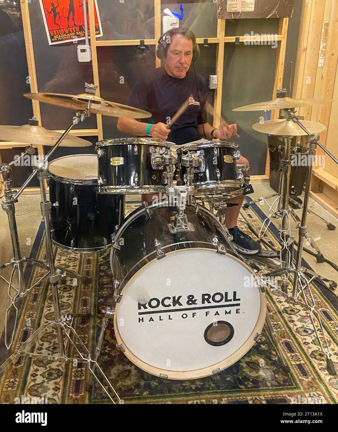 Cleveland, Ohio, USA - 4 August 2023: Man playintg on a drum set in a room at the rock and roll hall of fame. Stock Photo