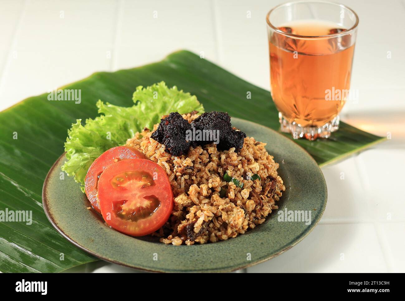 Nasi Goreng Rendang with Warm Tea, Rendang is Traditional Melayu Minang Beef Stew Stock Photo