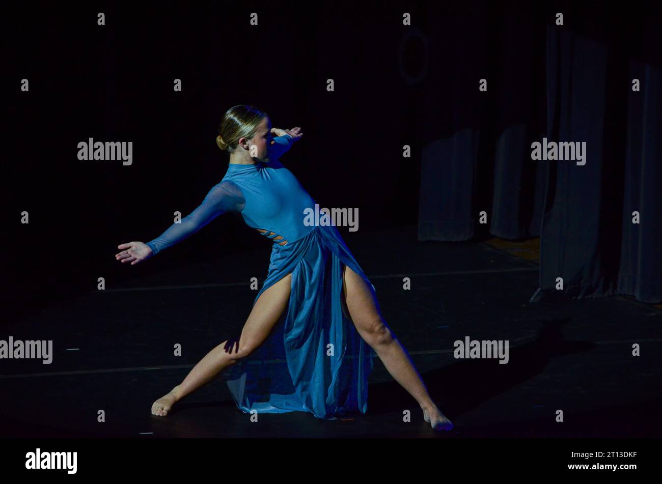 dancer striking a pose in the spotlight Stock Photo