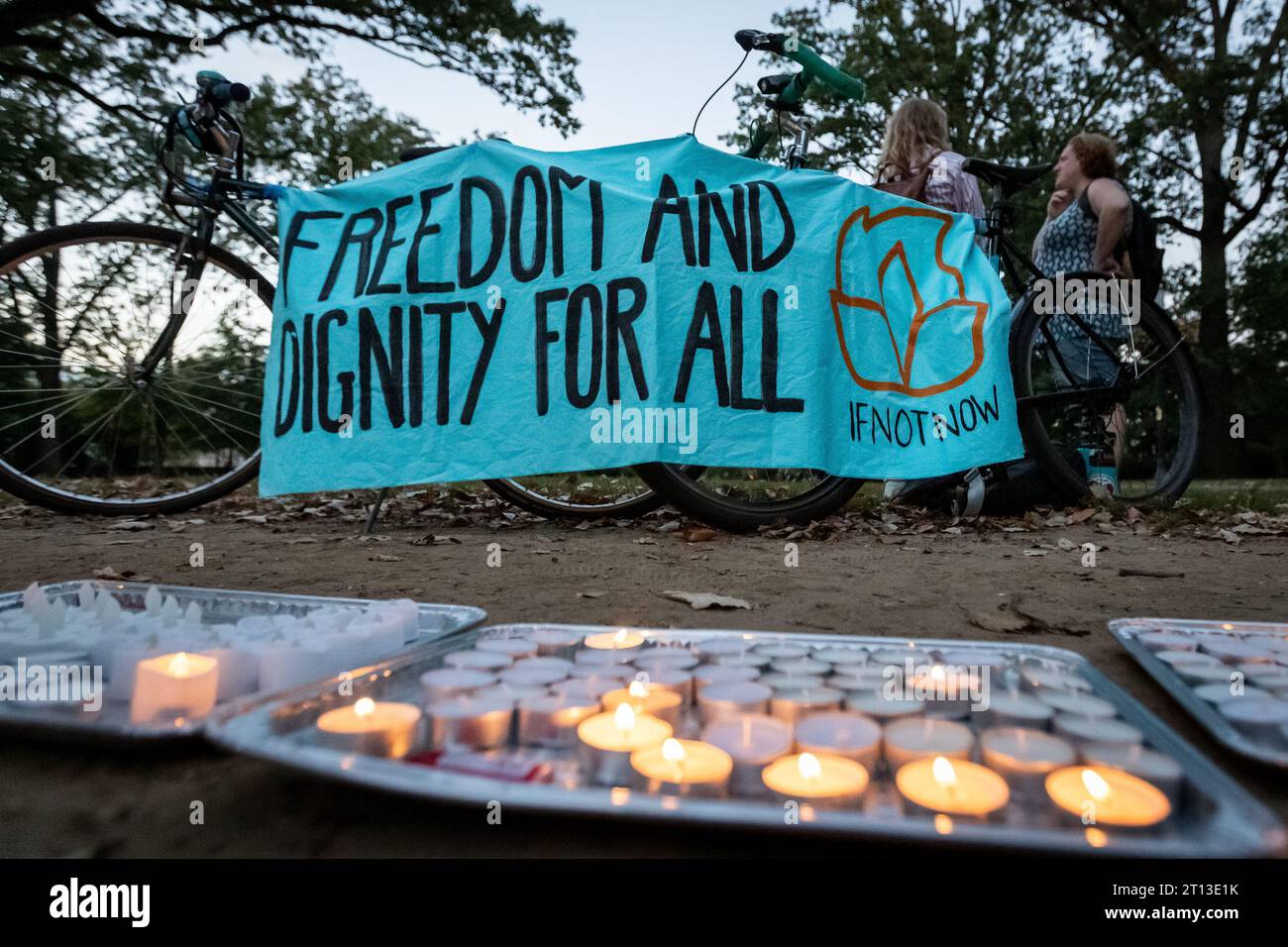 Washington, United States. 10th Oct, 2023. Candles sit below a banner during a vigil hosted by If Not Now to honor Israeli and Palestinian victims of decades of violence in the Middle East. (Photo by Allison Bailey/NurPhoto) Credit: NurPhoto SRL/Alamy Live News Stock Photo